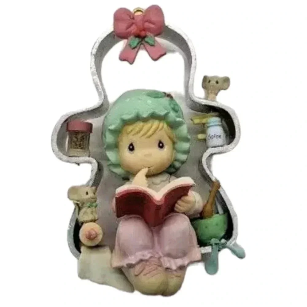 Precious moments girl perched on a cookie cutter christmas ornament